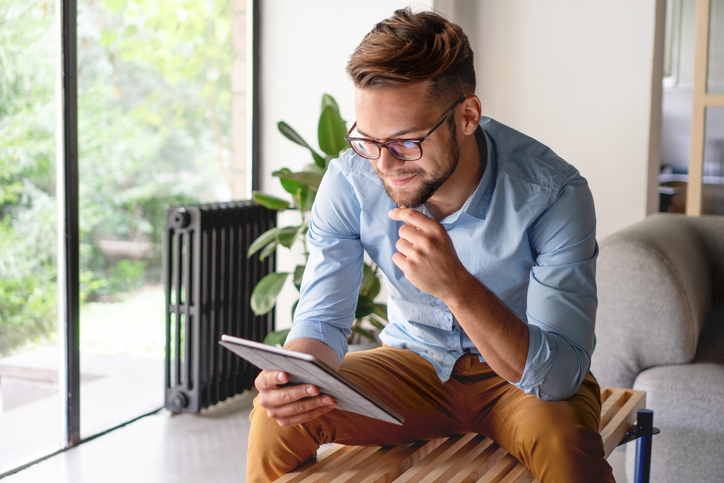 Young Man looking at digital tablet