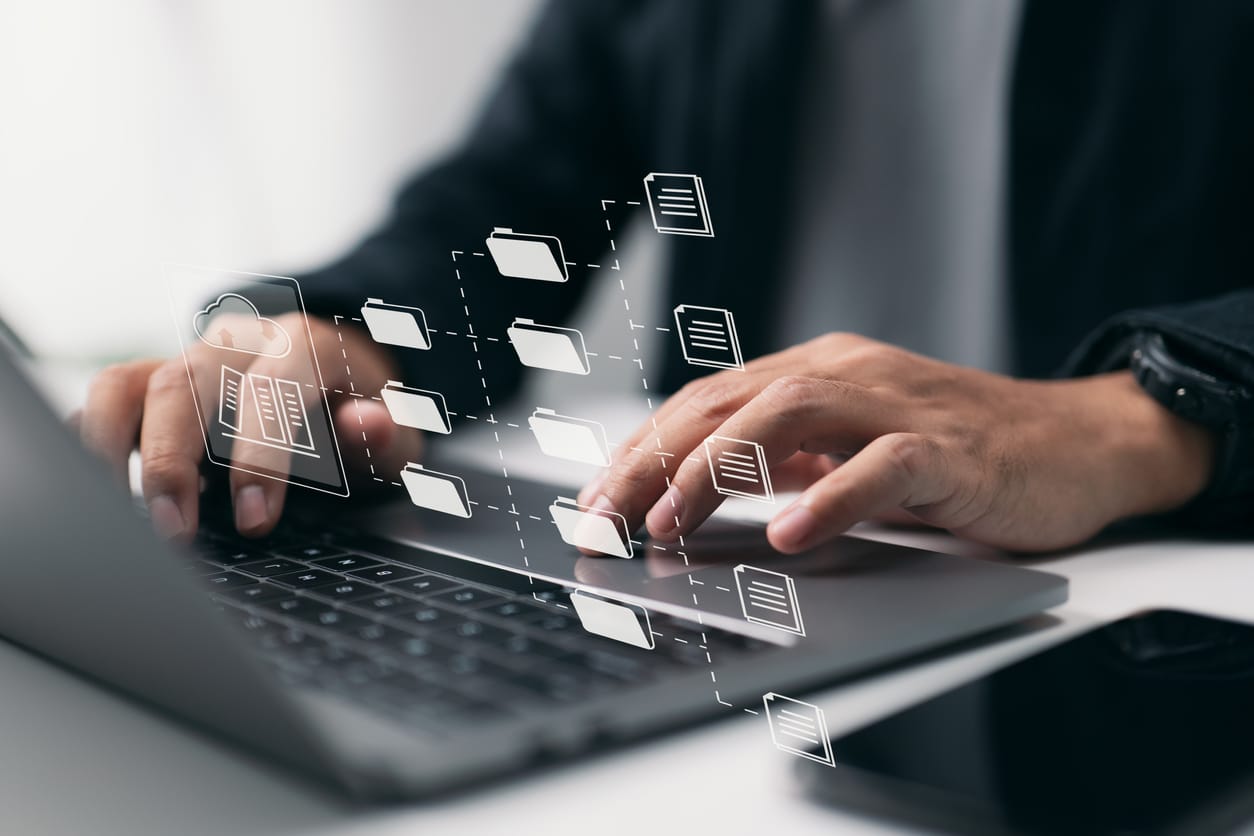 Man Looking At Data Catalog On Laptop