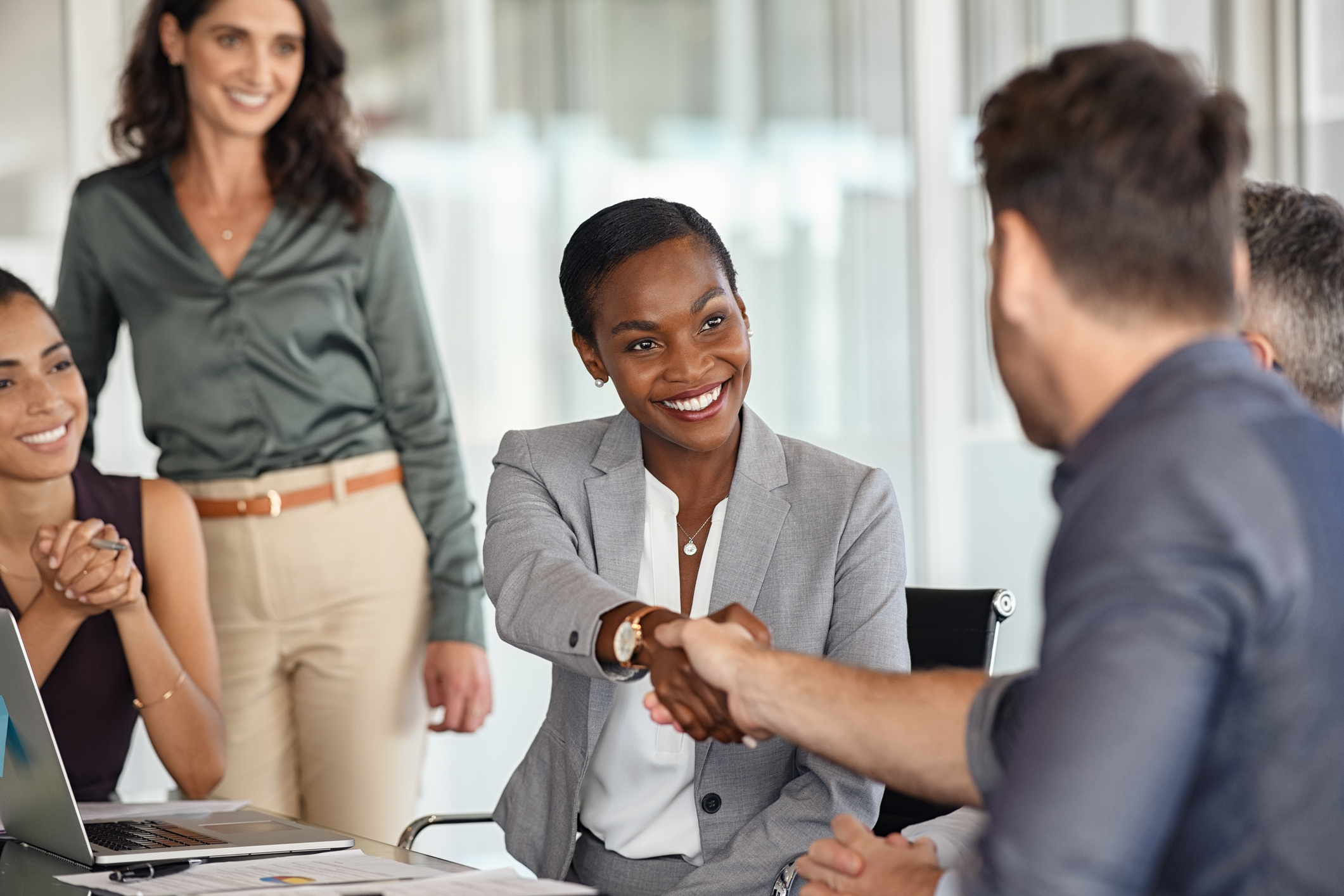 Mature black businesswoman shaking hands with new business partner