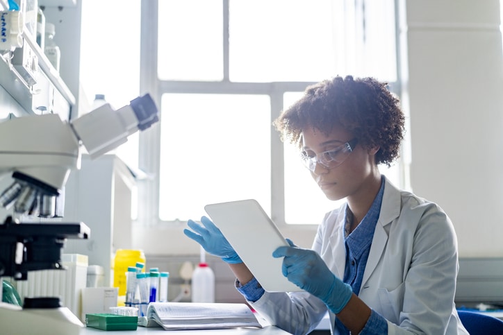 Young Female Scientist Using Digital Tablet In Lab