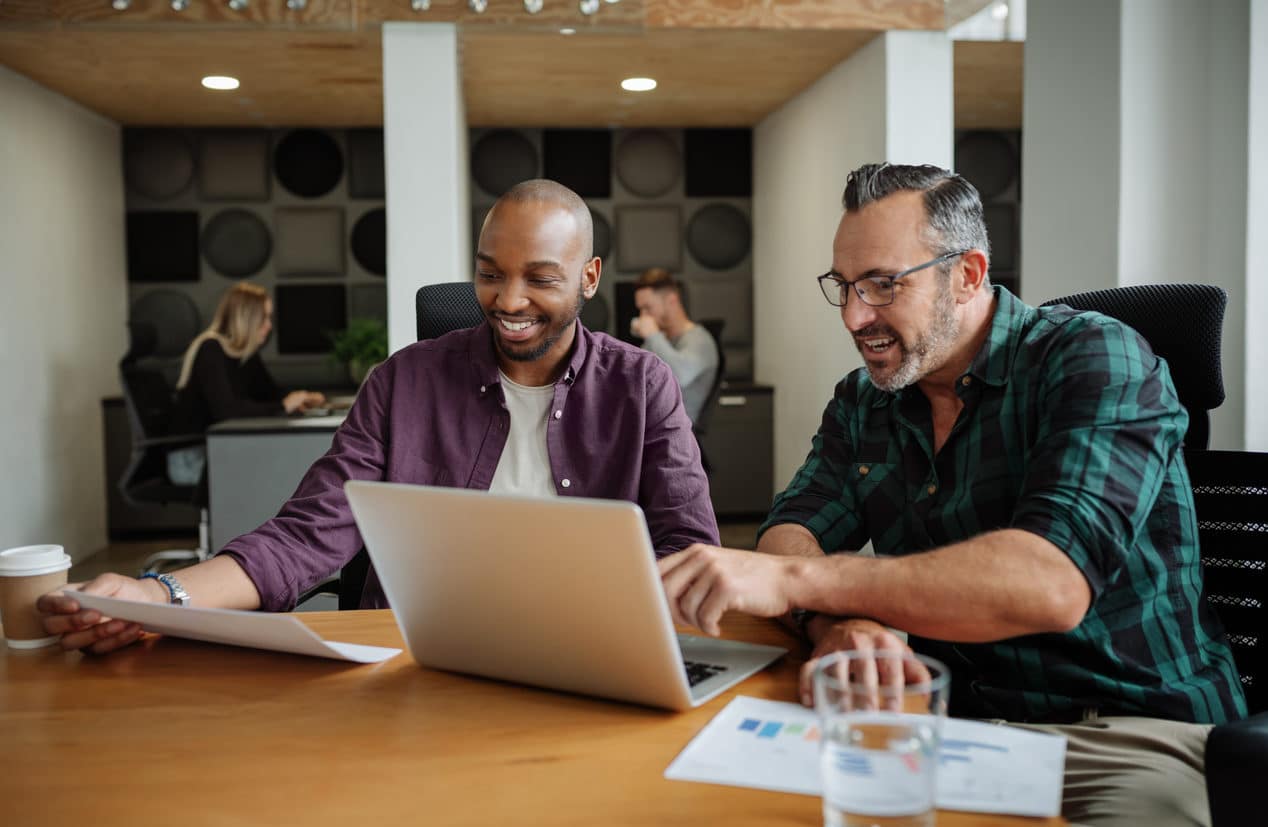 Two Diverse Businessmen Working In Modern Coworking Workspace