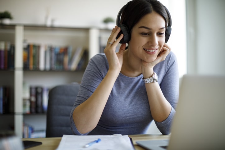 Young Woman With Headphones Working From Home