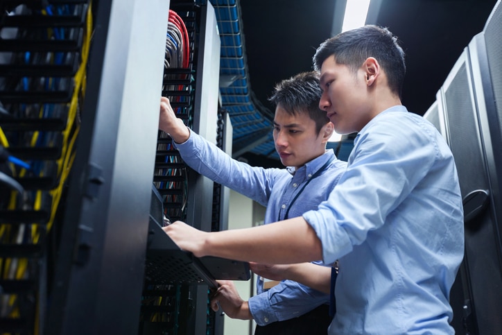 Young IT Engineers Inspecting Data Center Servers